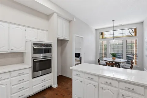a kitchen with appliances a sink and cabinets