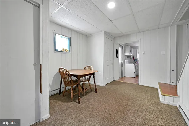 a bedroom with a bed and a flat tv screen on wall