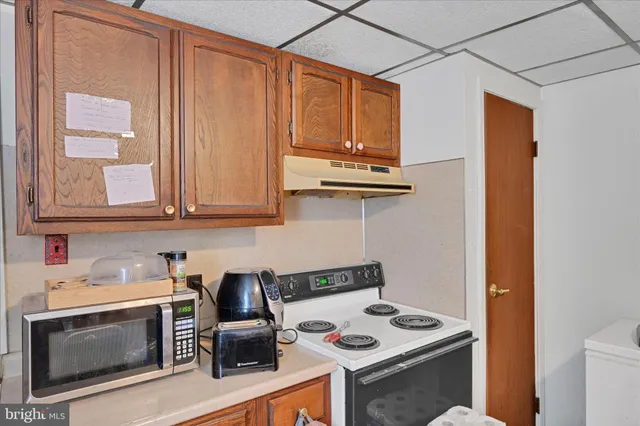 a kitchen with stainless steel appliances granite countertop a sink stove and microwave