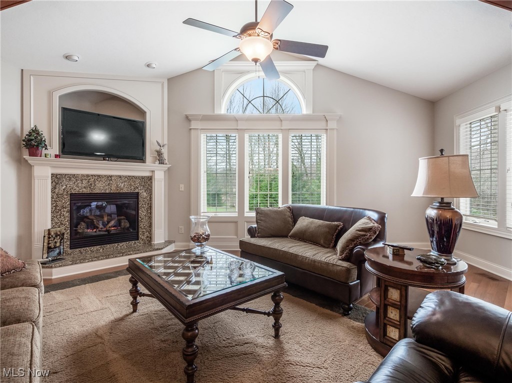 5349 Slater Ridge Westerville, OH 43082 - Photo 17 of 50 Living room with lofted ceiling, a ceiling fan, a premium fireplace, and wood finished floors