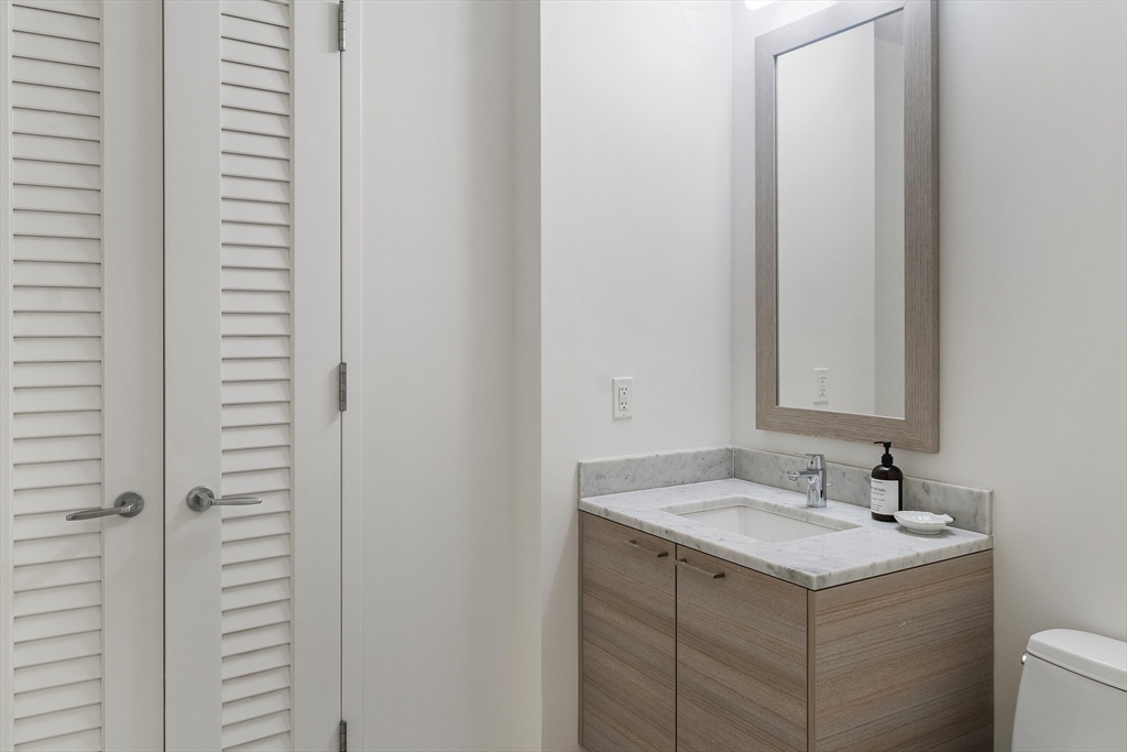 1 Franklin Street, Unit 1506 Boston, MA 02110 - Photo 14 of 32 a bathroom with a sink and a mirror