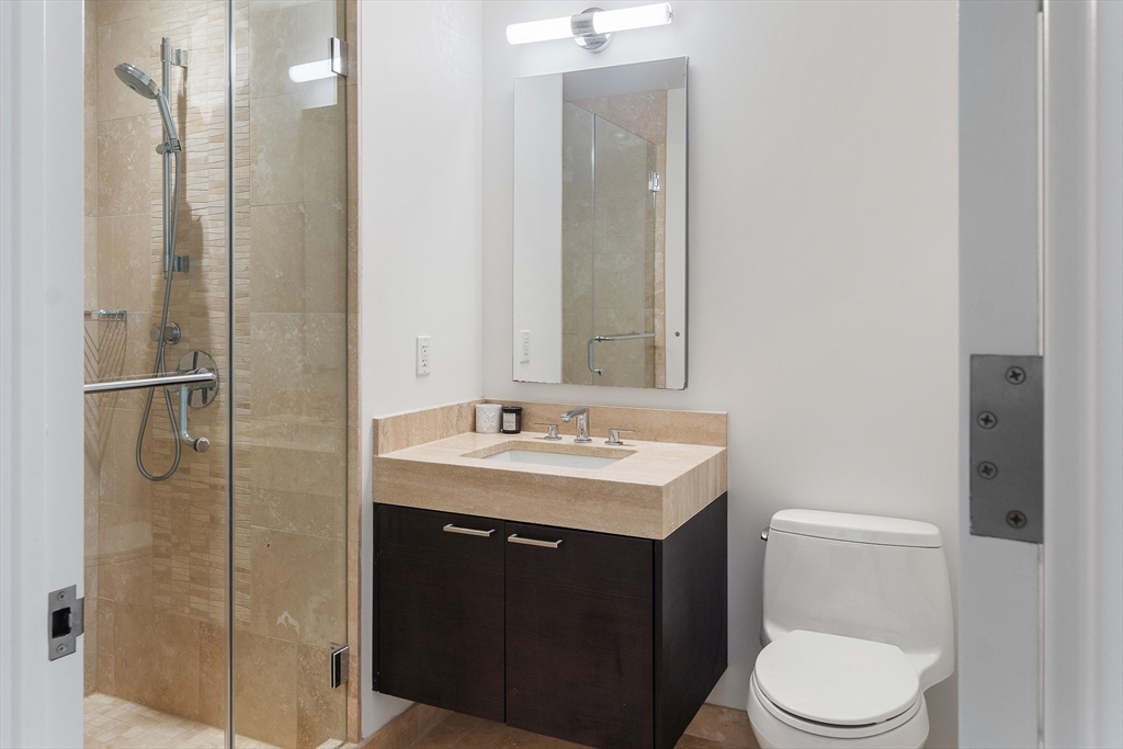 1 Franklin Street, Unit 1506 Boston, MA 02110 - Photo 8 of 32 a bathroom with a toilet a sink and shower