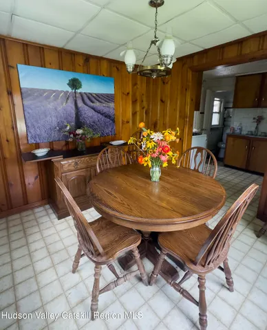 a dining room with a table and chairs