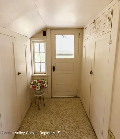 a view of a livingroom with wooden floor and a window
