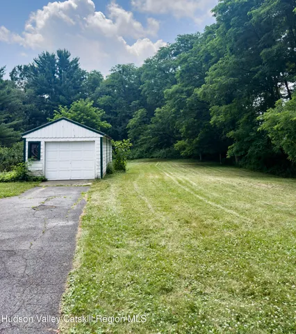 a front view of a house with yard and green space