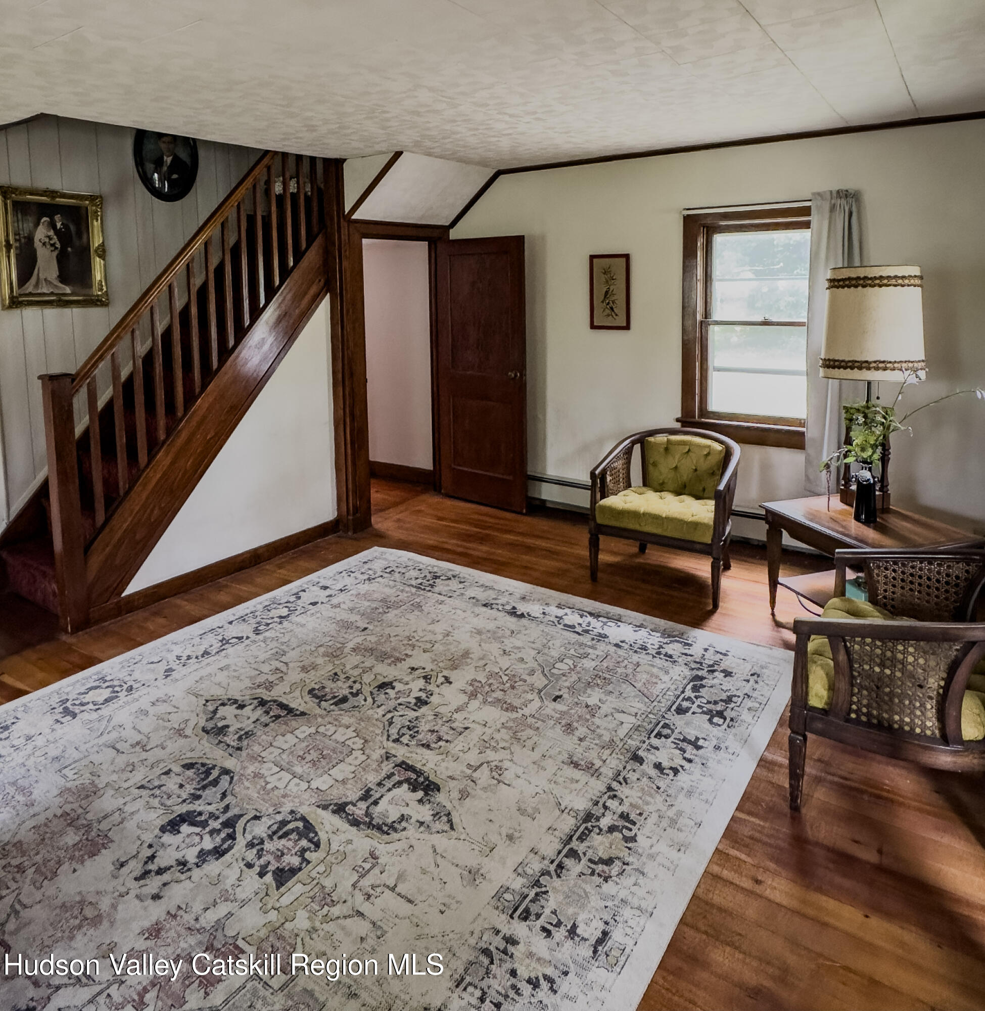 4359 County Route 81 Greenville, NY 12083 - Photo 4 of 26 a living room with furniture stairs and a wooden floor