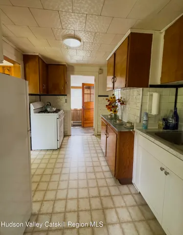 a kitchen with a sink and a stove top oven