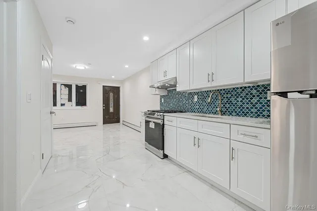a kitchen with white cabinets and white appliances