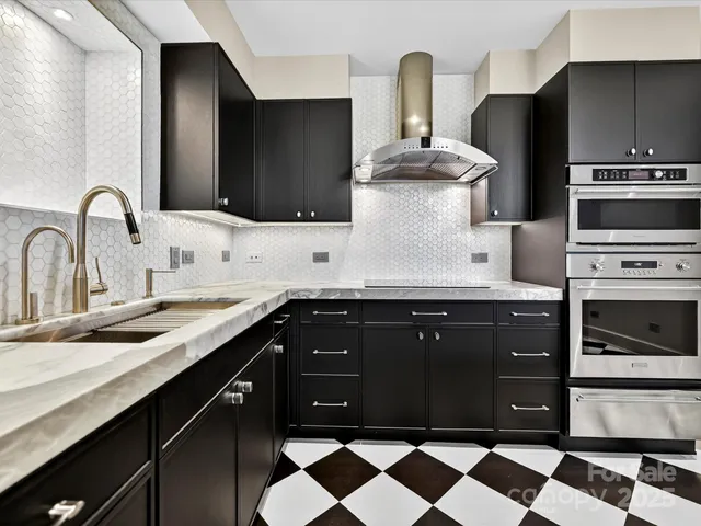 a kitchen with stainless steel appliances granite countertop a sink and a microwave