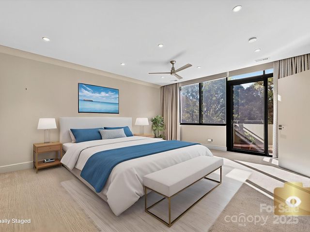 a spacious bedroom with a large bed and a large window