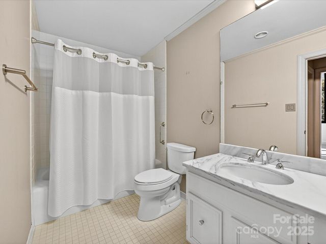 a room with a black white checkered floor with a white walls