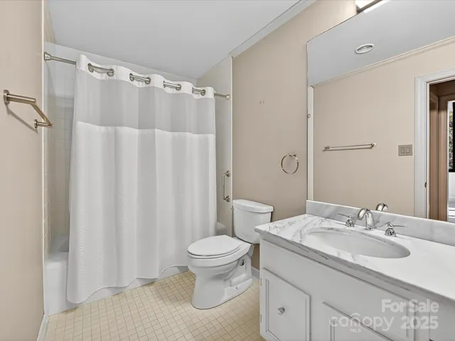 a room with a black white checkered floor with a white walls