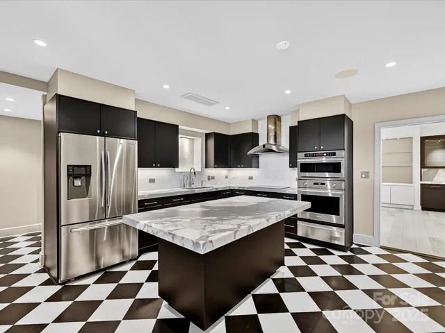a kitchen with stainless steel appliances a sink stove and refrigerator