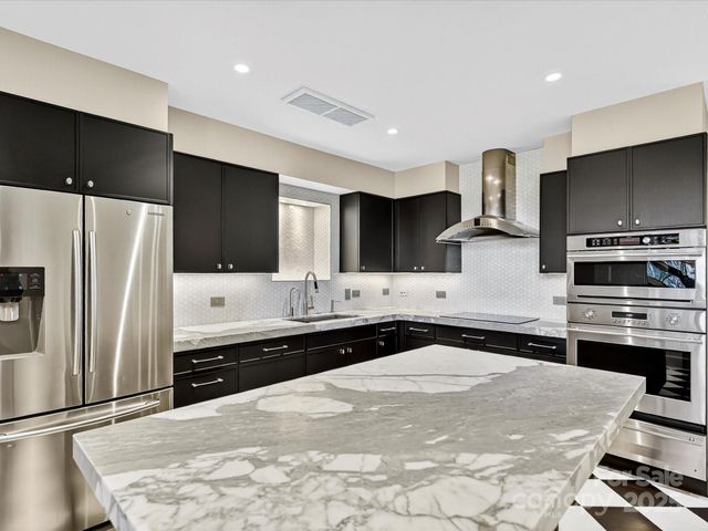 a kitchen with a sink stove and cabinets