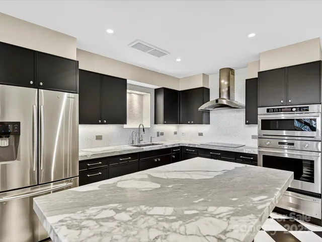 a kitchen with a sink stove and cabinets