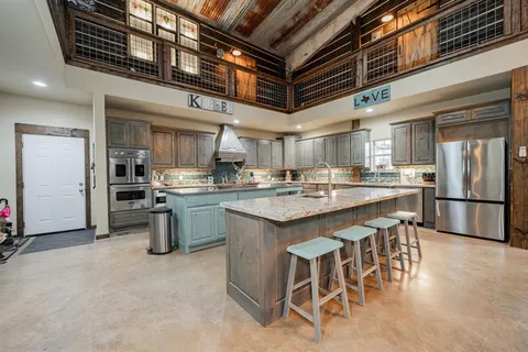 a kitchen with stainless steel appliances granite countertop a sink stove and cabinets