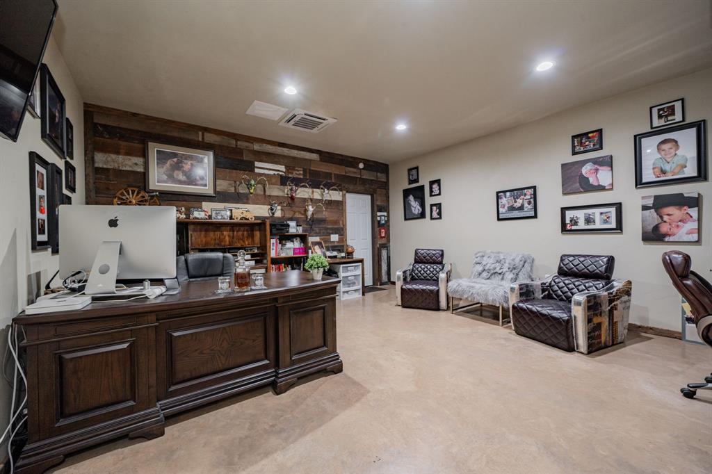 1990 Jim Harry Loop Sunset, TX 76270 - Photo 20 of 40 a room with furniture a flat screen tv and gym equipment