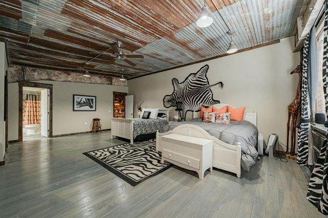 a bedroom with furniture and wooden floor