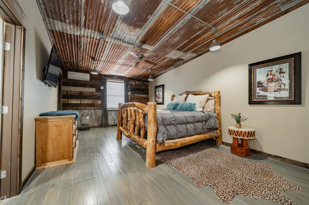1990 Jim Harry Loop Sunset, TX 76270 - Photo 25 of 40 a bedroom with furniture and wooden floor