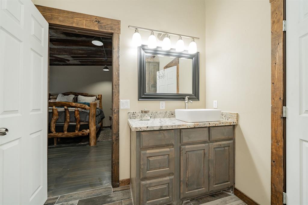 1990 Jim Harry Loop Sunset, TX 76270 - Photo 26 of 40 a en suite bathroom with a sink and a mirror