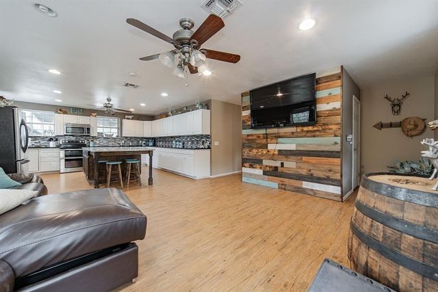 a view of the patio with table and chairs under an umbrella with a table and chairs
