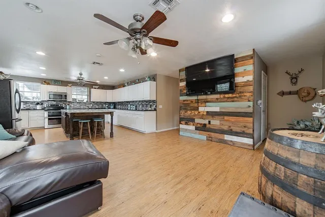 a view of the patio with table and chairs under an umbrella with a table and chairs