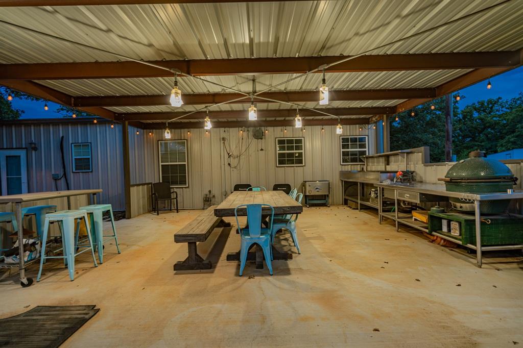 1990 Jim Harry Loop Sunset, TX 76270 - Photo 31 of 40 a view of the patio with table and chairs under an umbrella with a table and chairs