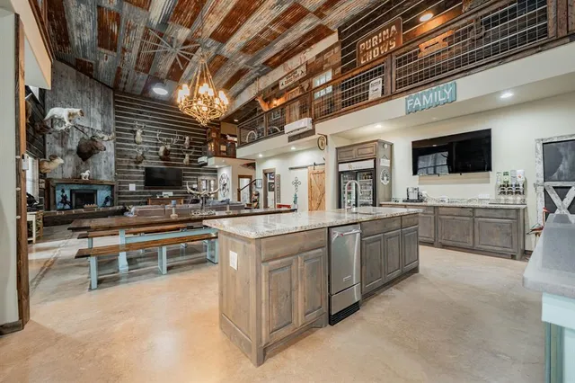 a kitchen with stainless steel appliances granite countertop a sink and white cabinets