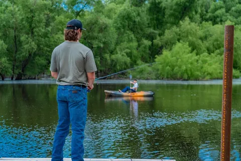 a swimming pool with a yard and outdoor seating