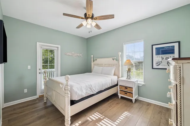 a bedroom with a bed and a ceiling fan