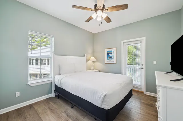 a bedroom with a bed tv and a window