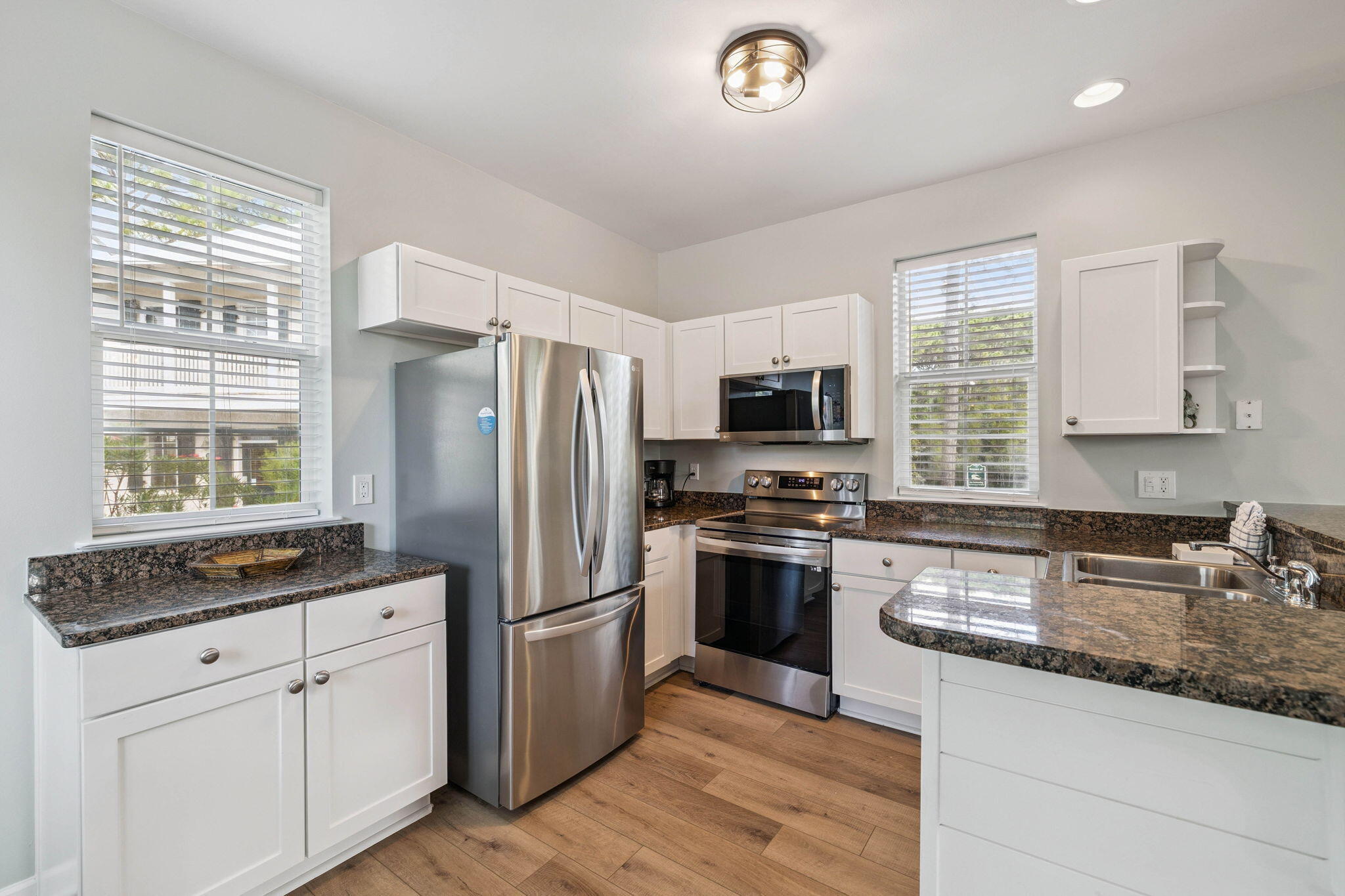 198 Somerset Bridge Road, Unit 114 Santa Rosa Beach, FL 32459 - Photo 8 of 28 a kitchen with stainless steel appliances granite countertop a stove a sink dishwasher a refrigerator and a stove