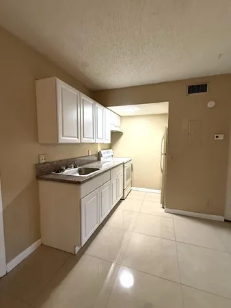 an empty room with closet and windows