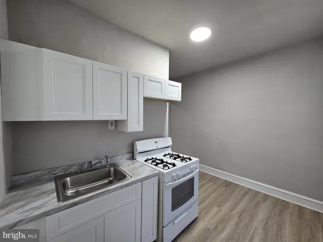 a kitchen with a stove and a sink