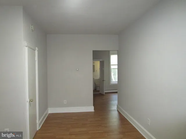 a view of hallway with wooden floor