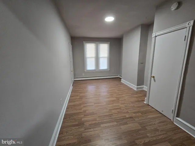 a view of hallway with wooden floor