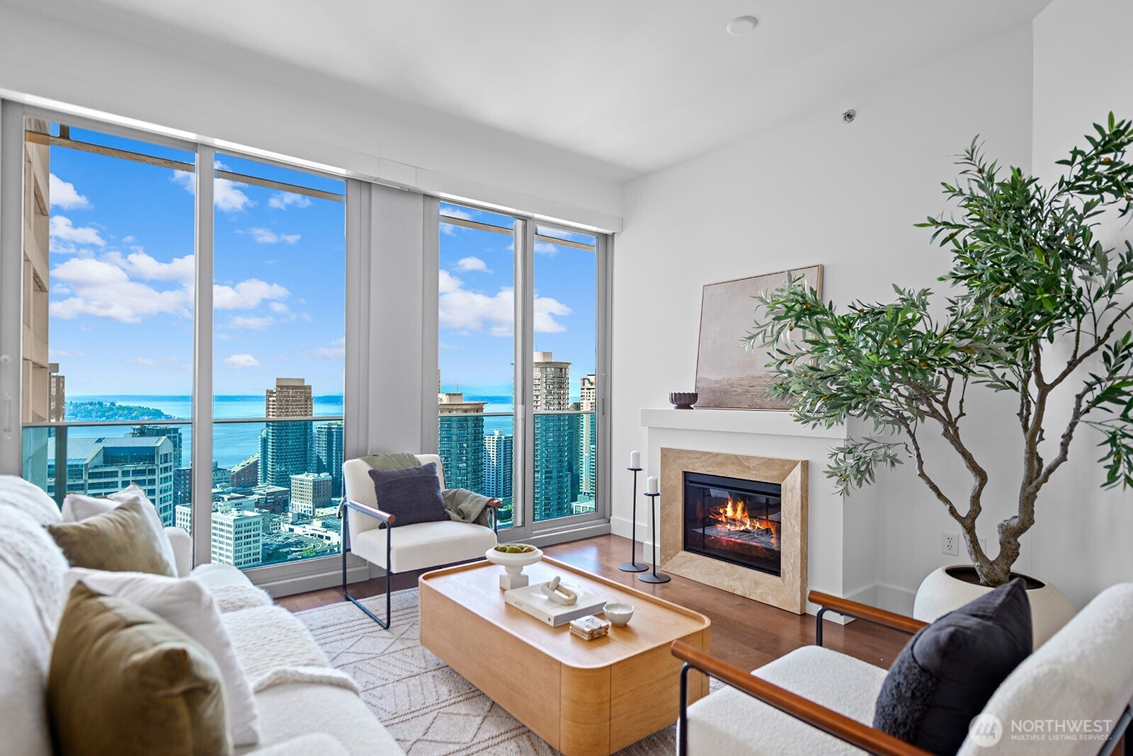 a living room with furniture large window and a fireplace