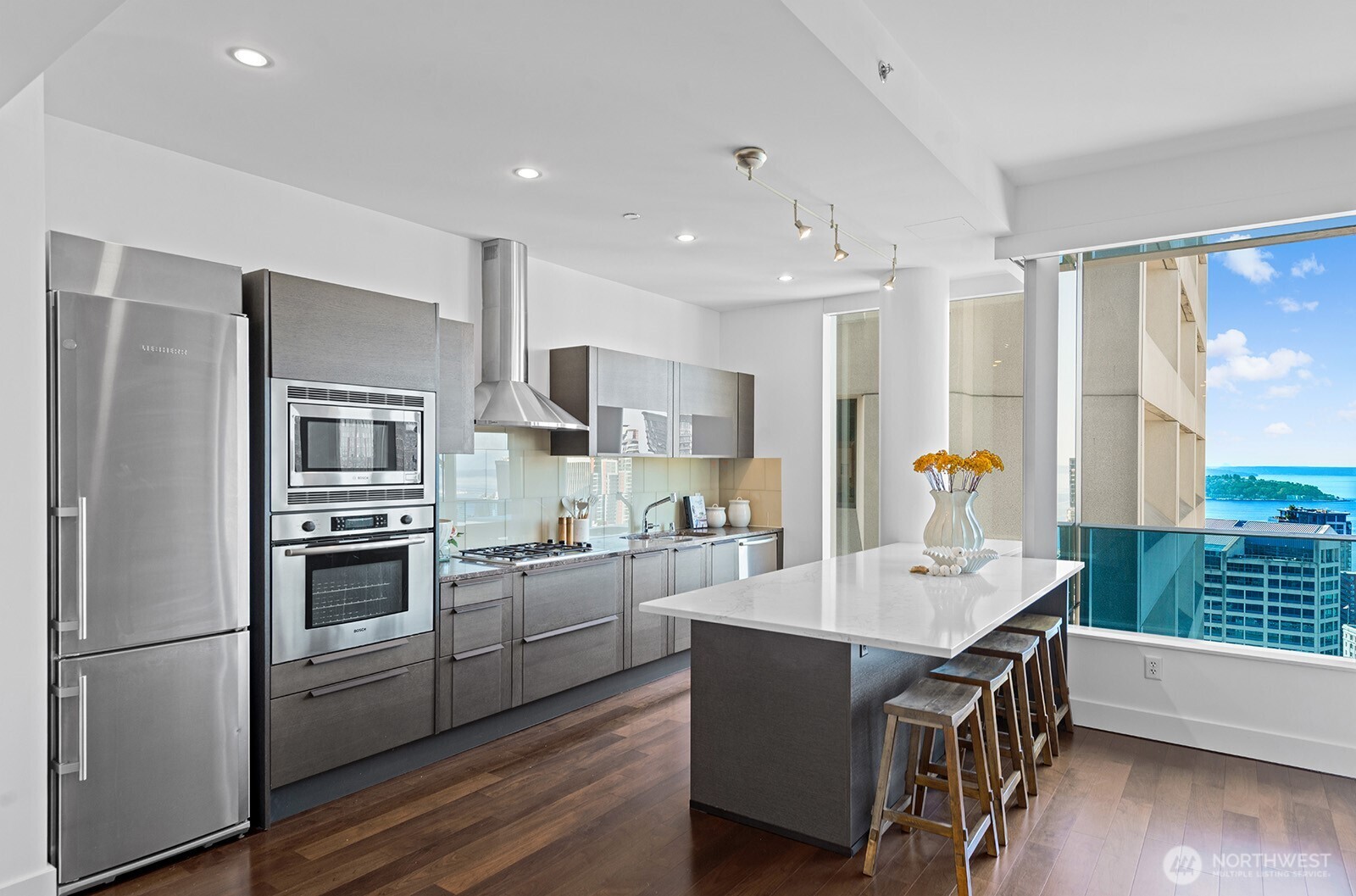 737 Olive Way, Unit 3509 Seattle, WA 98101 - Photo 11 of 31 a kitchen with a sink appliances and cabinets