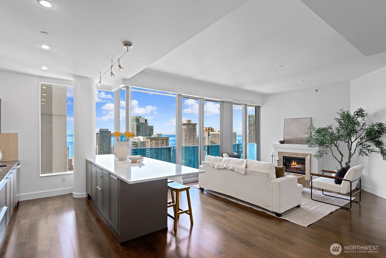 737 Olive Way, Unit 3509 Seattle, WA 98101 - Photo 13 of 31 a living room with furniture fireplace and a large window