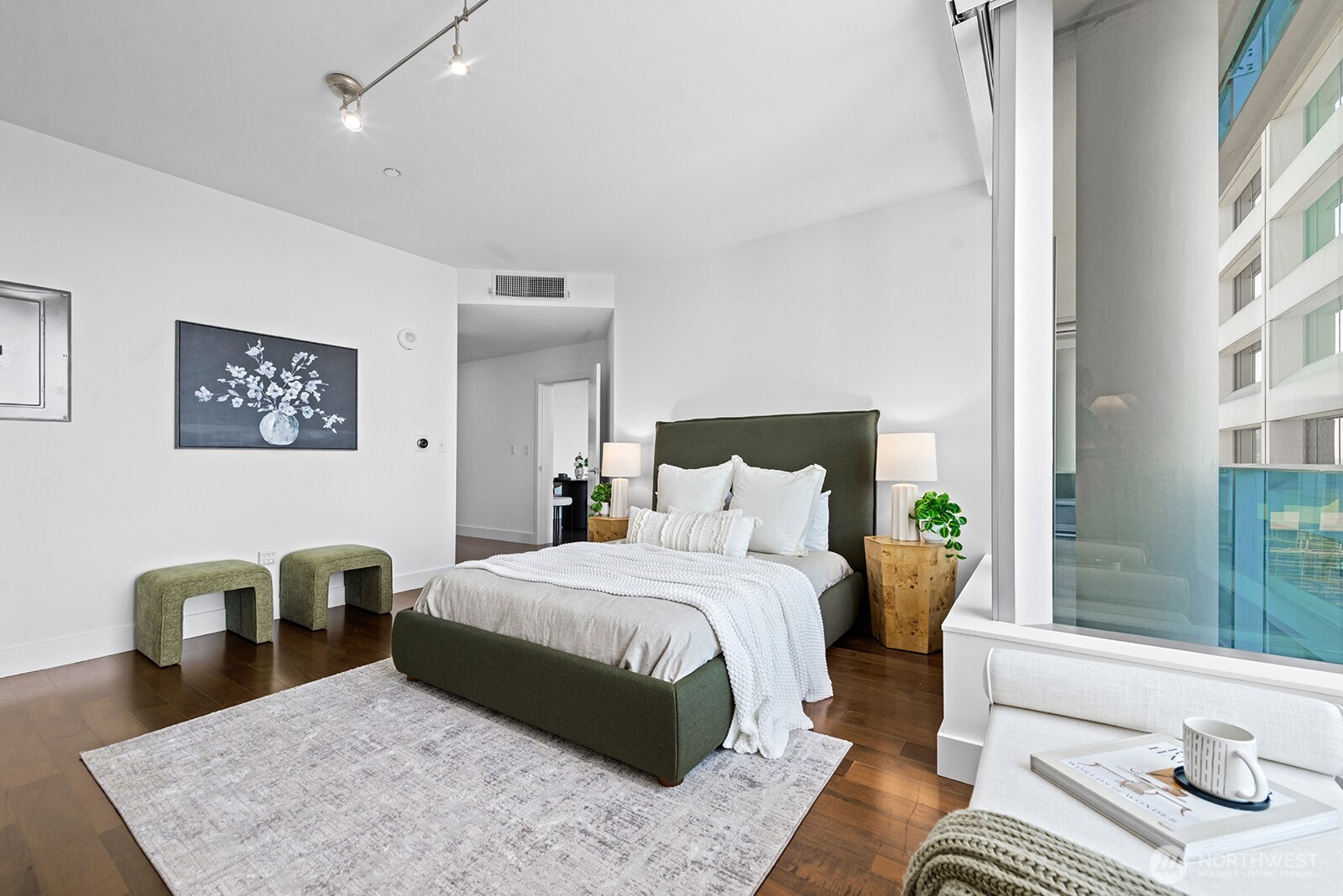 737 Olive Way, Unit 3509 Seattle, WA 98101 - Photo 17 of 31 a bedroom with a bed and wooden floor