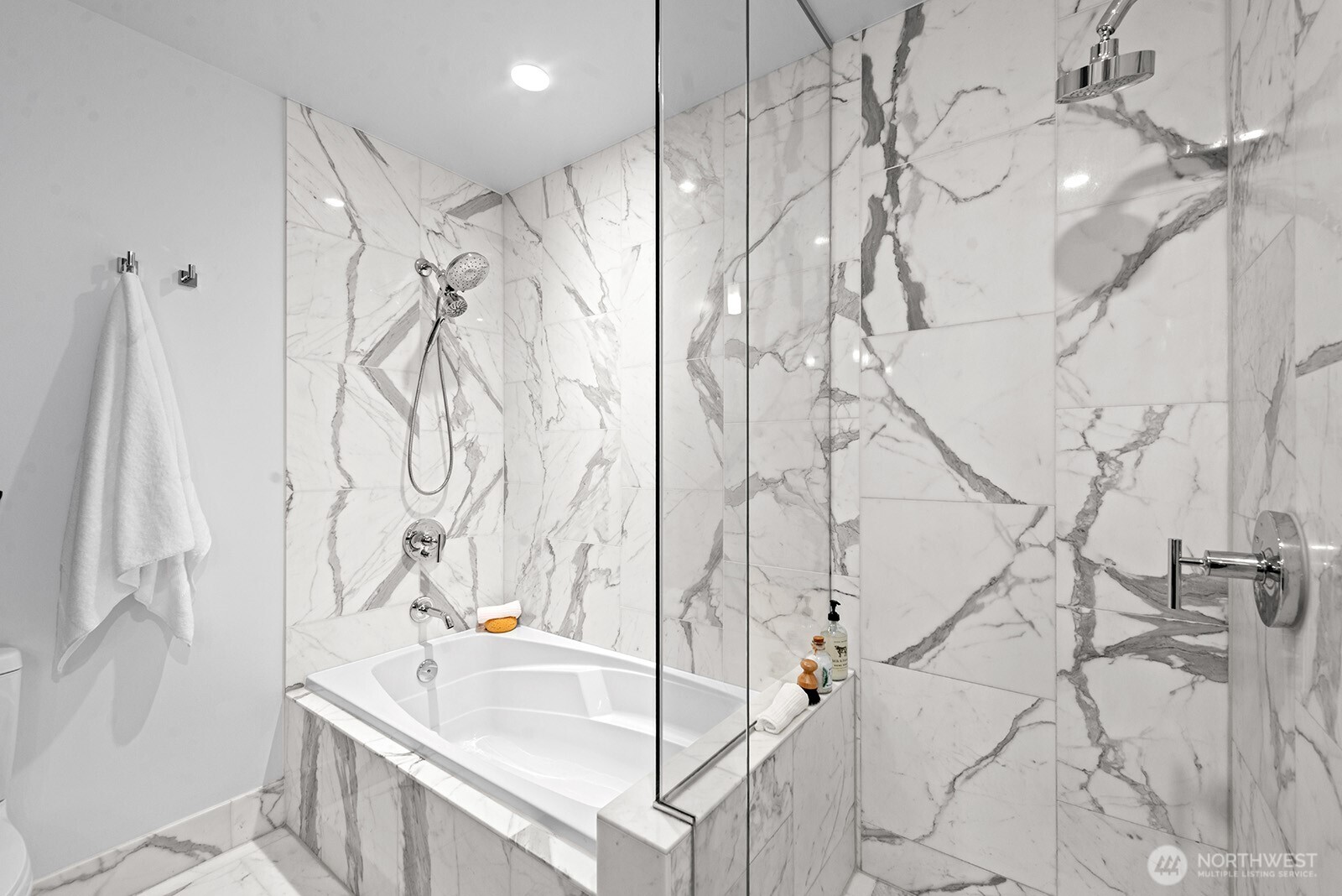 737 Olive Way, Unit 3509 Seattle, WA 98101 - Photo 19 of 31 a bathroom with a bathtub and shower