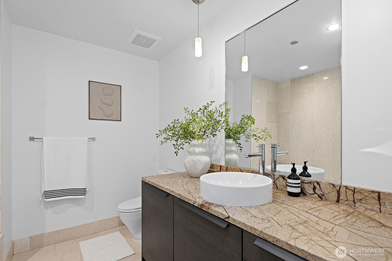 737 Olive Way, Unit 3509 Seattle, WA 98101 - Photo 24 of 31 a bathroom with a granite countertop sink a toilet and a mirror