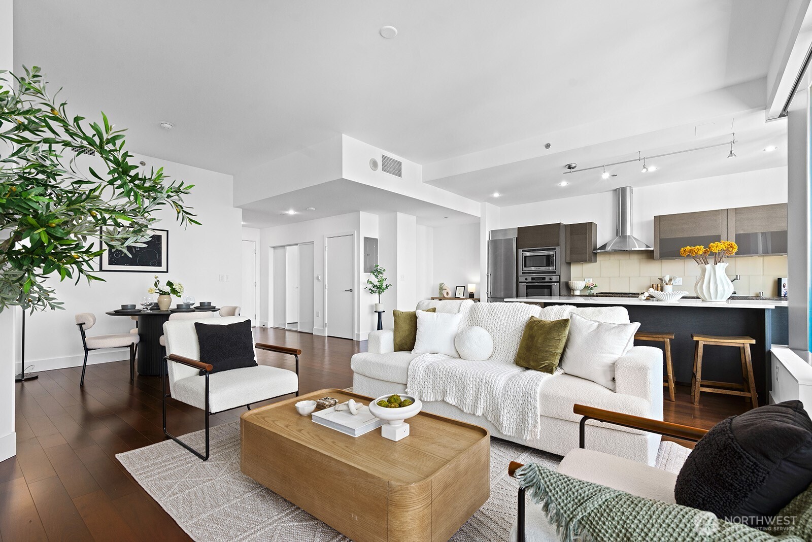 737 Olive Way, Unit 3509 Seattle, WA 98101 - Photo 5 of 31 a living room with furniture kitchen view and a potted plant