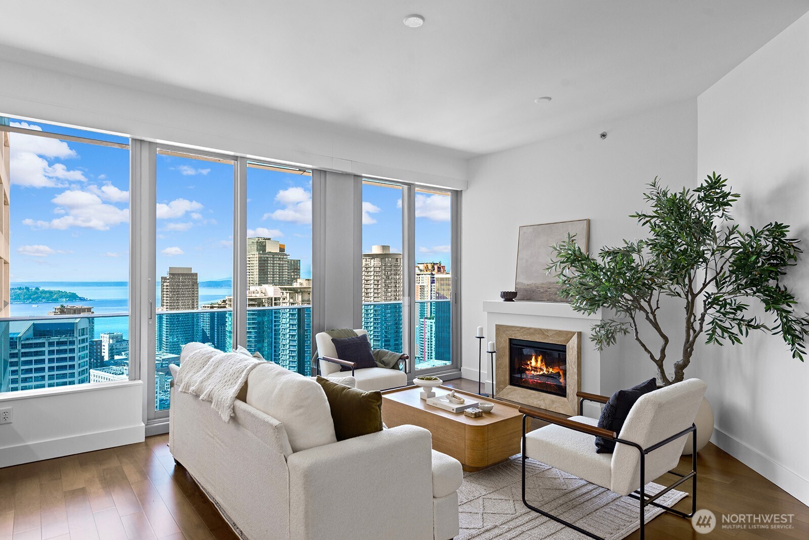 737 Olive Way, Unit 3509 Seattle, WA 98101 - Photo 6 of 31 a living room with furniture and a fireplace