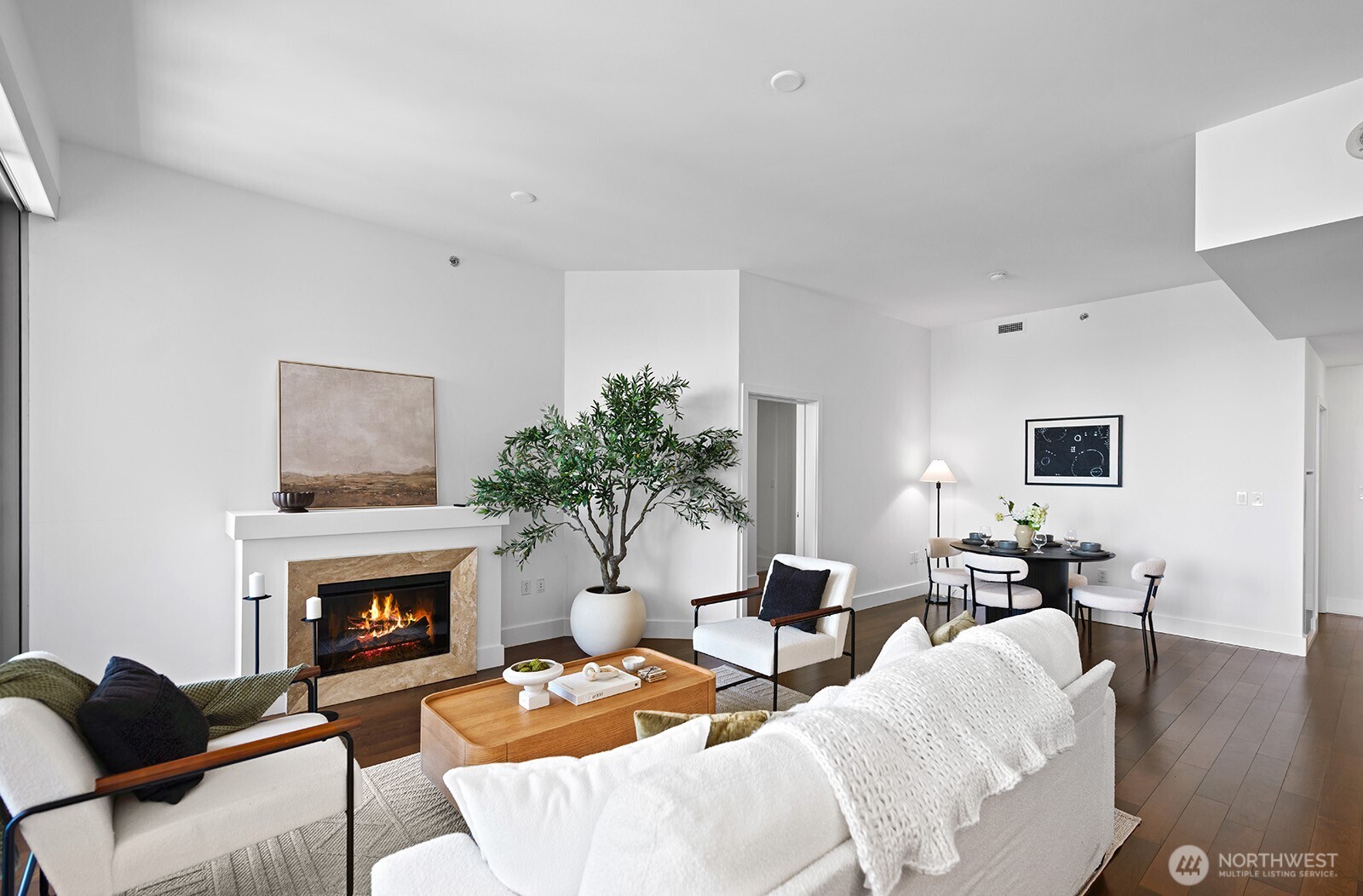 737 Olive Way, Unit 3509 Seattle, WA 98101 - Photo 7 of 31 a living room with furniture a fireplace and a potted plant