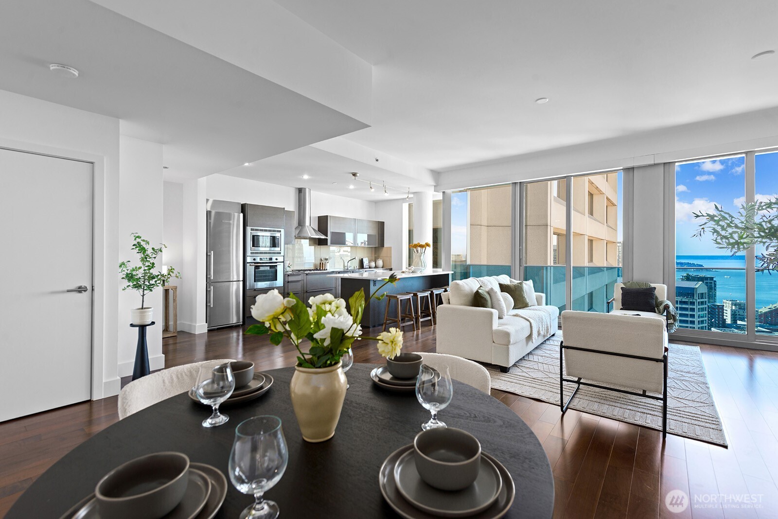 737 Olive Way, Unit 3509 Seattle, WA 98101 - Photo 8 of 31 a living room with furniture potted plant and a wooden floor