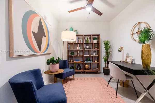 a living room with furniture and a potted plant