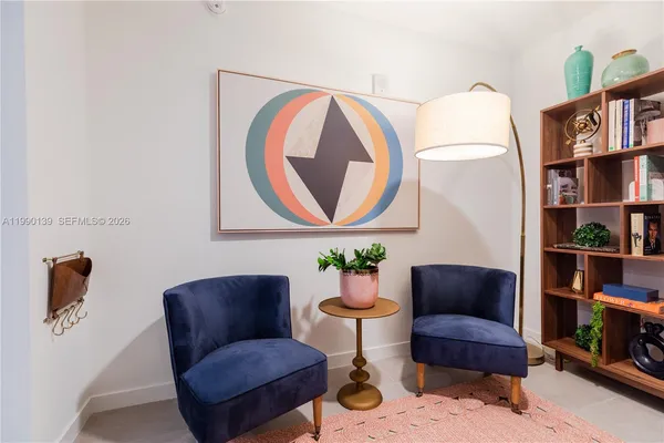 a living room with furniture and a book shelf