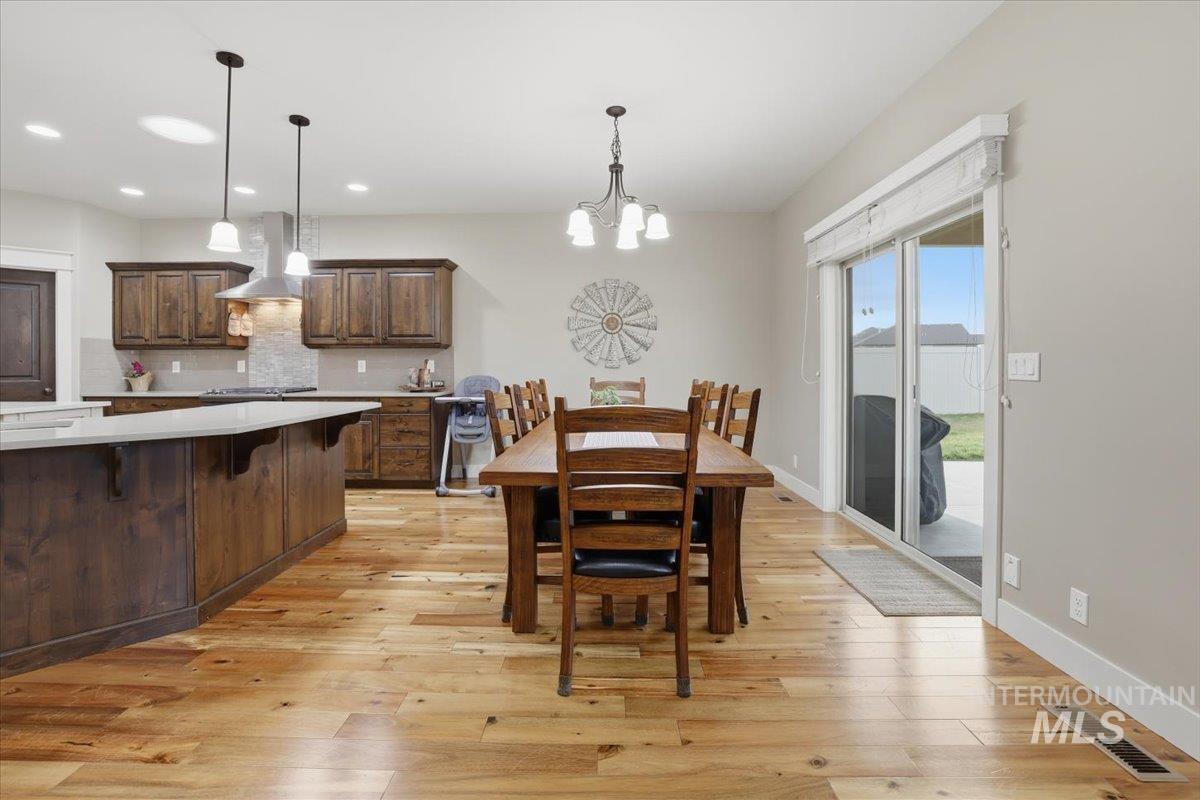 4604 Middlesboro Way Caldwell, ID 83607 - Photo 11 of 43 Dining space featuring a chandelier and light wood-style floors