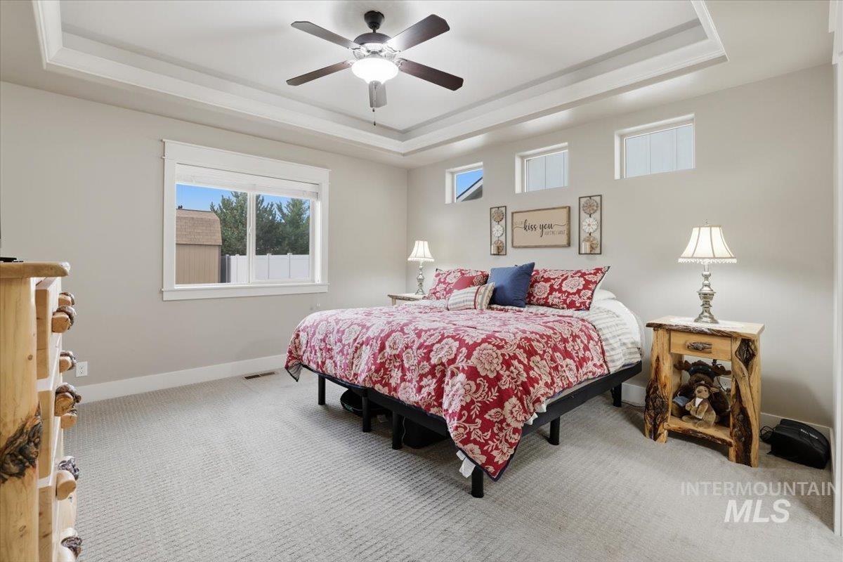 4604 Middlesboro Way Caldwell, ID 83607 - Photo 17 of 43 Bedroom featuring a raised ceiling, a ceiling fan, and carpet flooring